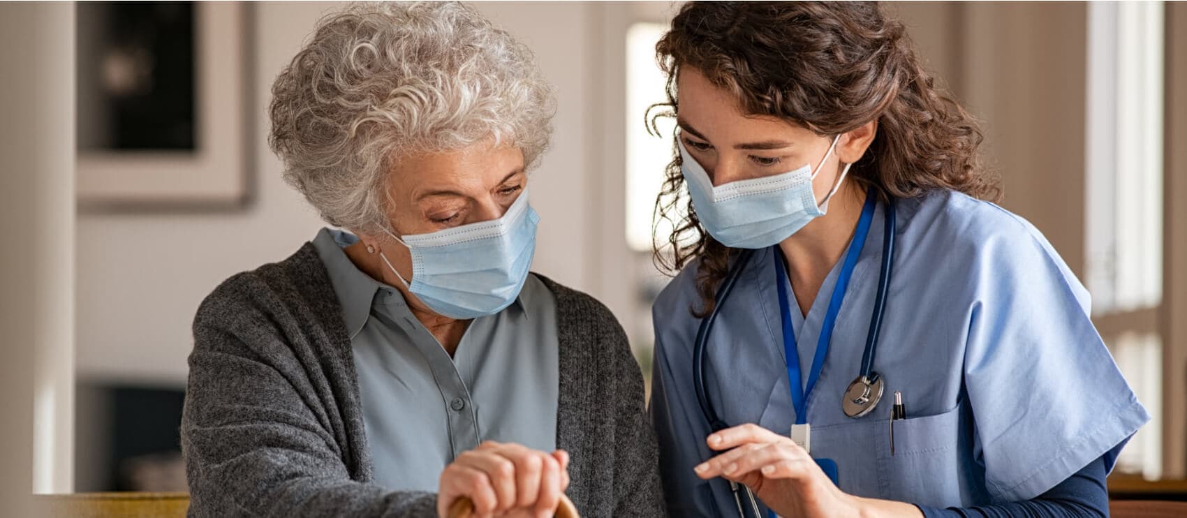 nurse and elderly woman looking at something